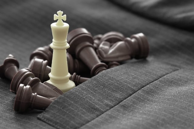 close up of chess figure on suit background strategy or leadership concept.jpeg